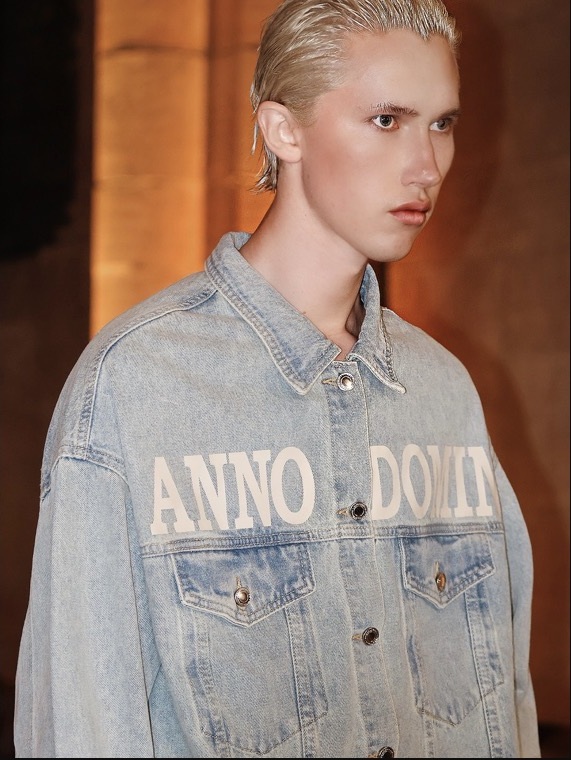 Model in a denim jacket backstage at Fashion Week